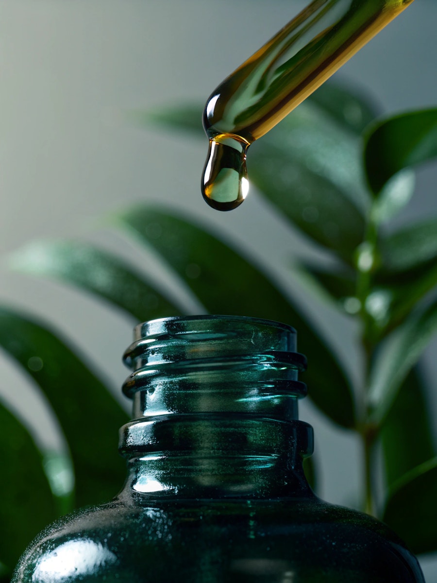 Glass Dropper Bottle With Liquid Droplet